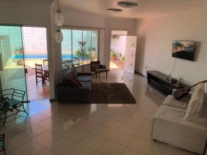 a living room with a couch and a table at Pousada do Bosque in Rio Branco