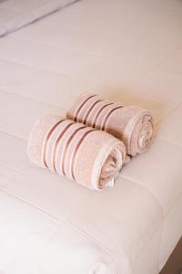 a stack of towels on a bathroom floor at SHUSHI APARTMENT in Lamai