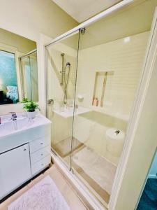 a bathroom with a glass shower and a sink at Entire 4 Bed Rooms Sanctuary in West Hoxton