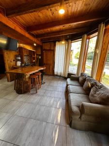 a living room with a couch and a wooden table at Reserva los Bollenes in Constitución