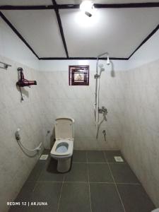 a bathroom with a toilet and a shower at nalin and song in Sigiriya