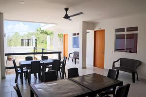 a dining room with a table and chairs at Habitacion Manglares 101 in Coveñas +8 photos