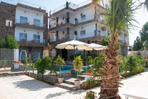 a hotel with a swimming pool in front of a building at Lake House Hotel in Luxor