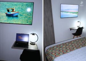 a hotel room with a laptop on a bed and a table at Quinta Park 43 in Bogotá