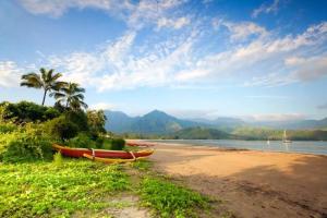 two boats sitting on the shore of a beach at Simple & Fun Rooftop Camper SUV Gear-Included Glamping Adventure in Kauaʻi in Anahola