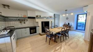 a kitchen and dining room with a table and chairs at Belle vue in Dournazac
