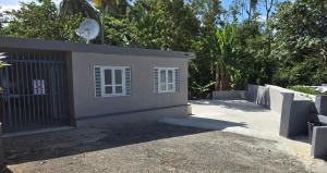 a small house with a gate and a fence at RiverHouse Luquillo in Ramos