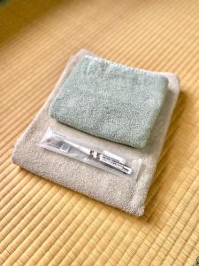 a thermometer sitting on top of a towel on a table at 民泊Nao in Minami Alps