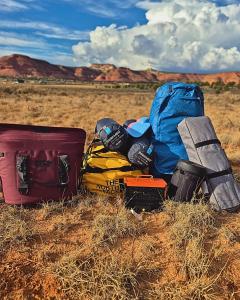 a pile of luggage sitting on the ground in a field at Campkit - Premium Camping Kit, Pickup in Kanab - Camp Anywhere in Kanab