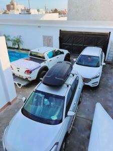 two cars parked next to each other in a garage at Casa de Playa en Lobos in Cerro Azul