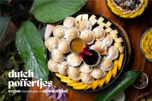 a plate of dutch food on a wooden table at Wonderland in Siquijor +28 photos