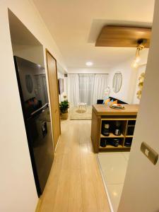 a kitchen with a black refrigerator and a wooden floor at San Miguel Apartment Ocean Magic in Lima