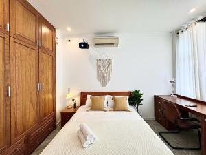 a bedroom with a bed and a dresser and a desk at Rù Rì Homestay - Walk 5 minutes to the Airport in Ho Chi Minh City