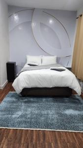 une chambre avec un grand lit et un tapis dans l'établissement Casa lux boutique guest house, à Newcastle