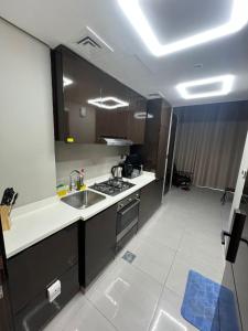 a kitchen with a sink and a counter top at Studio in Business Bay with Huge Balcony & Pool View near to Metro in Dubai