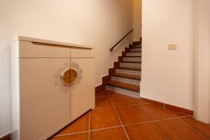 a hallway with a staircase with a door and a set of stairs at Sweet Home Botanico in Adeje