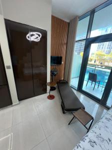 a bedroom with a treadmill and a room with a view at Studio in Business Bay with Huge Balcony & Pool View near to Metro in Dubai