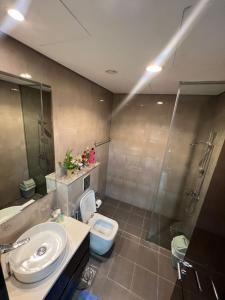 a bathroom with a sink and a toilet and a shower at Studio in Business Bay with Huge Balcony & Pool View near to Metro in Dubai