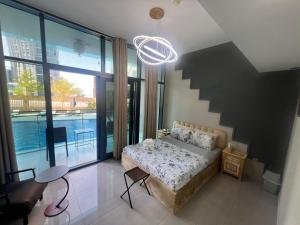 a bedroom with a bed and a large window at Studio in Business Bay with Huge Balcony & Pool View near to Metro in Dubai +13 photos