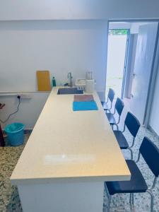 a conference room with a long table and chairs at Tanjung Bungah Holiday Home 4BR 20Pax 6Carpark in Tanjung Bungah