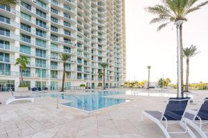 a large apartment building with a swimming pool and palm trees at Blue Harbour Amazing views 5 min downtown in Fort Myers