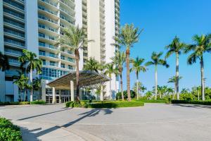 a large building with palm trees in front of it at Blue Harbour Amazing views 5 min downtown in Fort Myers