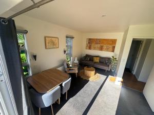 a living room with a table and a couch at Wheatstone Hideaway in Gisborne