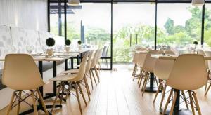 a dining room with tables and chairs and windows at Venue 88 in Dulongabong
