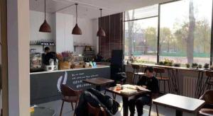 a woman sitting at a table in a restaurant at 7 Days Premium Beijing Dabaotai Metro Station Luhua Road in Beijing