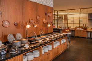 a buffet line with plates and utensils in a restaurant at ART HOTEL Nippori Lungwood in Tokyo