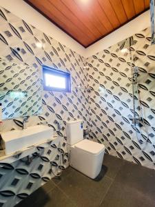 a bathroom with a toilet and a sink at Sithujaya Green Mirissa in Mirissa +34 photos