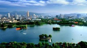 a large lake with a city in the background at Xana Hotelle Jinan Daminghu North Gate in Jinan