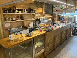 a kitchen with a counter with food on it at Albergo Garni Barancio in Auronzo di Cadore