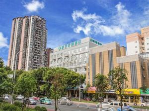 a city with tall buildings and a street with cars at City Comfort Inn Nanning Jiangnan Wanda Plaza in Nanning