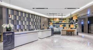 a lobby of a store with a counter and a table at Echarm Hotel Huangshi Yingbin Avenue in Huangshigang