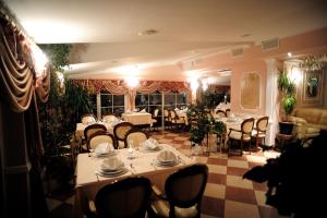 a dining room with tables and chairs in a restaurant at Hotel Mozart in Špišić-Bukovica