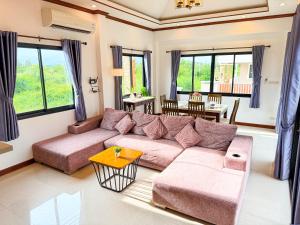 a living room with a couch and a table at Pran Suk Pool Villa pranburi 