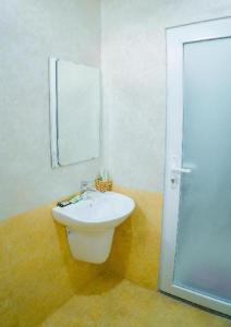 a bathroom with a white sink and a mirror at Hong Ha Hotel in Pleiku Airport