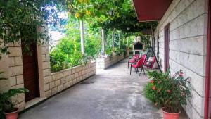 a walkway with chairs and tables on a building at Apartments Radis in Zaton