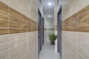 a hallway with wooden walls and a potted plant at Super Hotel O Ashoka Classic Near Gokul Chat in Hyderabad