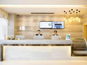 two people sitting at a counter with their laptops at City Comfort Inn Changsha Huangxing Avenue Airport Longhua Metro Station in Changsha