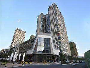 a building with tall buildings in a city at City Comfort Inn Kunming High Speed Railway South Station Yongxin Harvard in Kunming