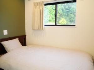 Postel nebo postele na pokoji v ubytování トレーラーホテル市原鶴舞インター店