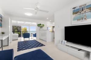 a living room with a large flat screen tv at Luxury Pool Retreat Ocean & Mountain Views in Scarborough