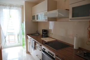 a kitchen with a sink and a stove top oven at Ferienwohnung Fuchs in Hannover