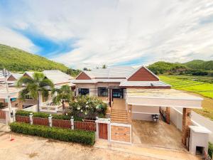 an image of a house with a fence at Pran Suk Pool Villa pranburi 