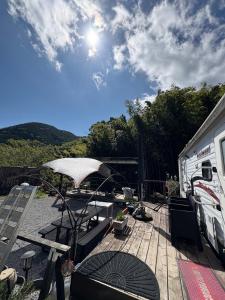 a deck with an rv and a table and an umbrella at The Basecamp Yugawara - Vacation STAY 84742v in Miyakami