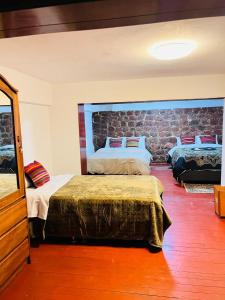 Ένα ή περισσότερα κρεβάτια σε δωμάτιο στο SkyGuest Cusco San Cristobal