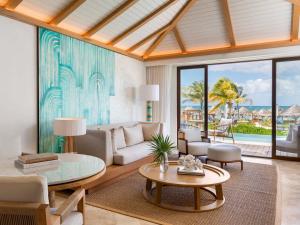 a living room with a couch and a table at Fairmont Mayakoba in Playa del Carmen