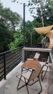 a patio with two chairs and a table and a hammock at TheNyaman Place in Hulu Langat